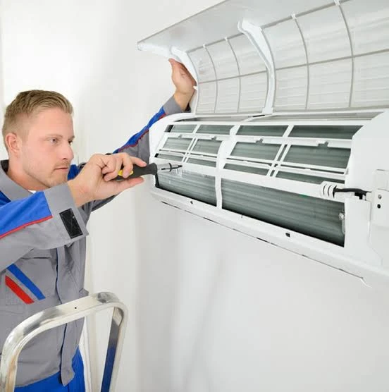 Technician installing a modern ductless air conditioning split system