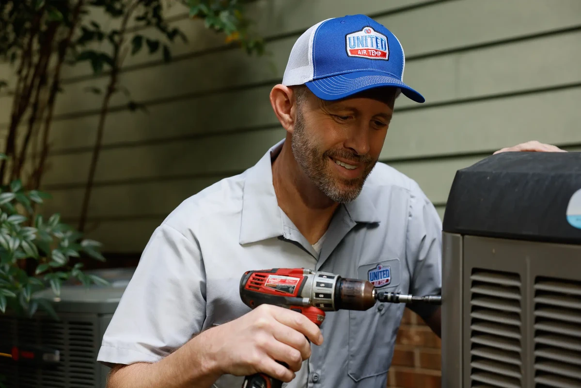 HVAC technician servicing a residential air conditioning system in Quakertown Pennsylvania