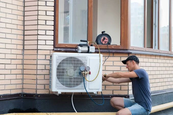 Technician servicing residential heat pump system in Quakertown area